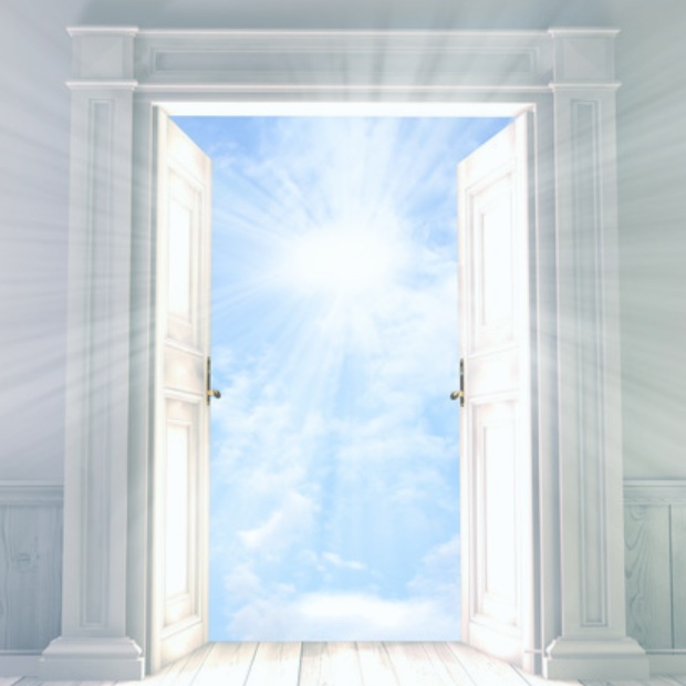 An open double door in a bright white room reveals a radiant sky filled with sunlight and soft clouds, symbolizing a divine or spiritual threshold.