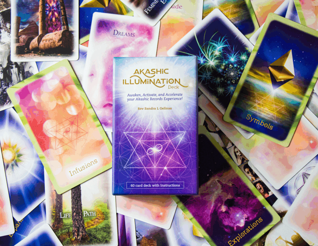 Card from the Akashic Illumination Deck spread out with the card deck box centered on top.