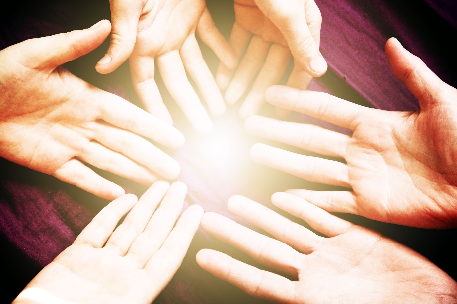 Community hands joined in light